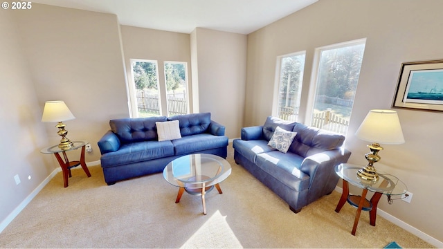 carpeted living area featuring baseboards