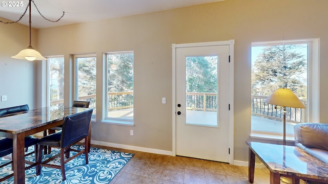 dining area featuring baseboards and light tile patterned flooring