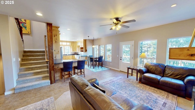 living room featuring stairway, recessed lighting, baseboards, and ceiling fan