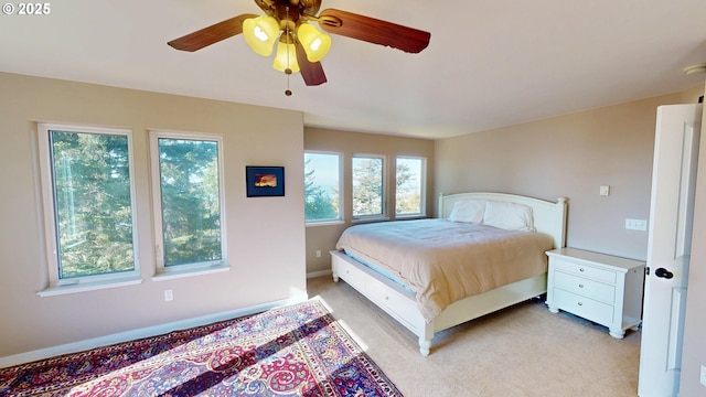 bedroom featuring ceiling fan and light carpet