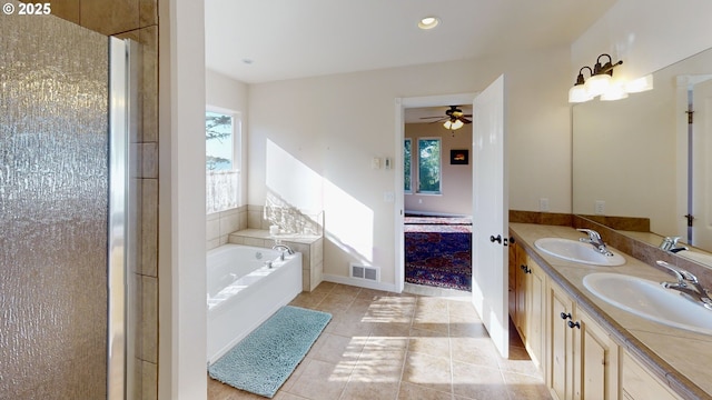 bathroom featuring a sink, visible vents, a wealth of natural light, and a bath