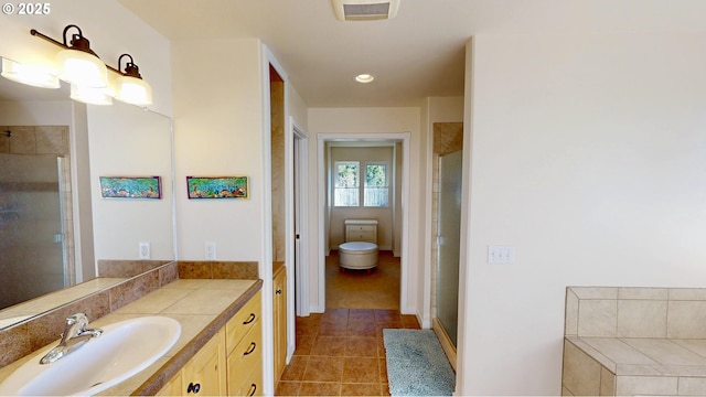 full bath featuring vanity, a shower stall, visible vents, and tile patterned floors