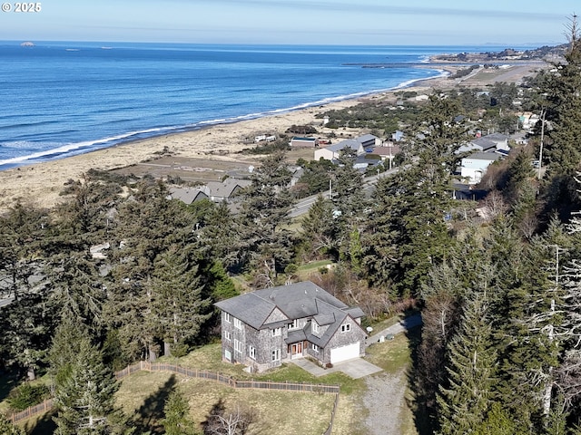 birds eye view of property with a beach view and a water view