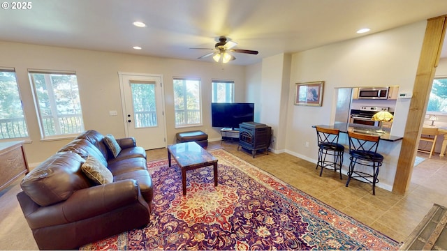 living area featuring a wealth of natural light, recessed lighting, and baseboards