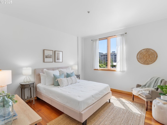 bedroom featuring baseboards and wood finished floors