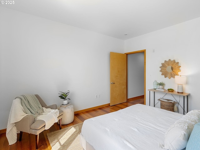 1030 NW Johnson St Unit 520, Portland, OR 97209 - bedroom with baseboards and wood finished floors