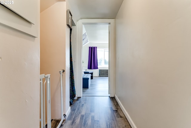 hallway with hardwood / wood-style floors