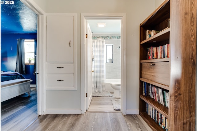 corridor with light hardwood / wood-style floors