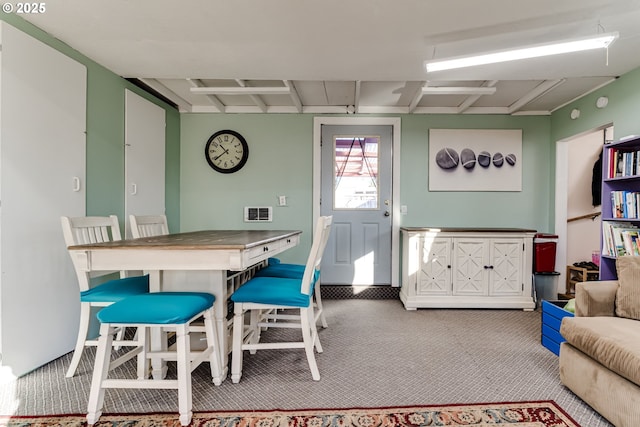 dining area with light colored carpet