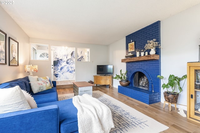 living area with wood finished floors and a fireplace