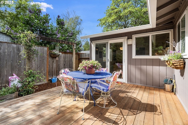 wooden deck featuring outdoor dining area and fence
