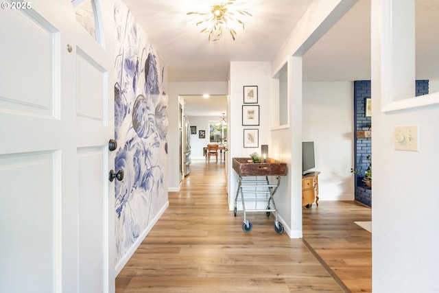 foyer featuring light wood-style floors and baseboards
