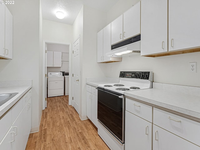 4320 S Corbett Ave Unit 206, Portland, OR 97239 - kitchen featuring white range with electric stovetop, under cabinet range hood, independent washer and dryer, light wood-style flooring, and light countertops