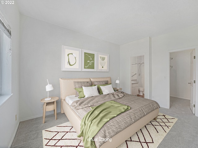 4320 S Corbett Ave Unit 206, Portland, OR 97239 - bedroom with light carpet, connected bathroom, a spacious closet, and baseboards