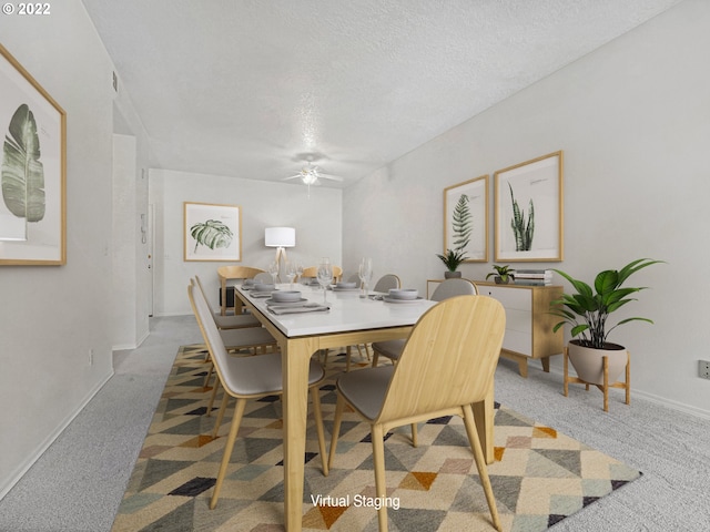 4320 S Corbett Ave Unit 206, Portland, OR 97239 - dining space with a ceiling fan, carpet, a textured ceiling, and baseboards