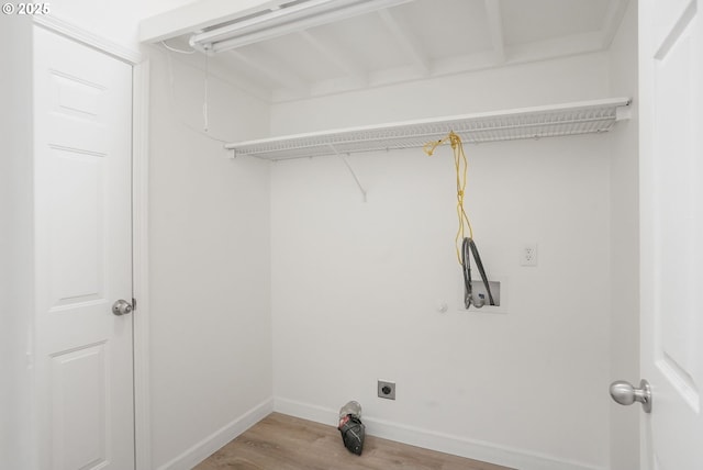 clothes washing area with hardwood / wood-style flooring, hookup for an electric dryer, and hookup for a washing machine