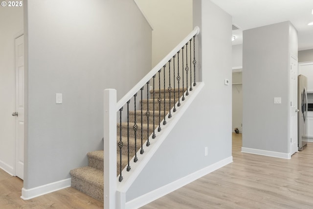 stairway featuring hardwood / wood-style flooring