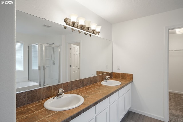 bathroom featuring independent shower and bath and vanity