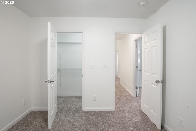 unfurnished bedroom with carpet and a closet