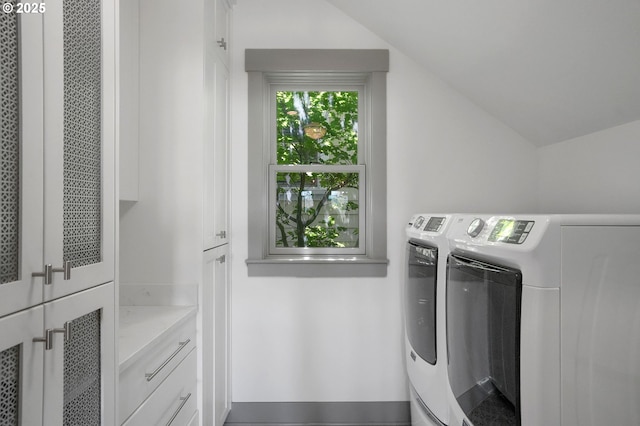 laundry area with cabinet space and separate washer and dryer