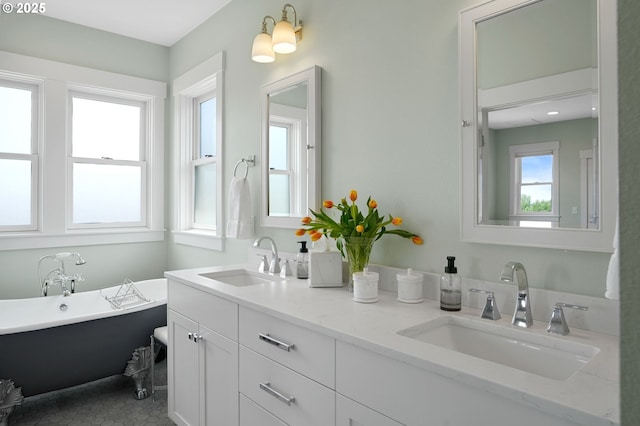 bathroom with double vanity and a freestanding tub