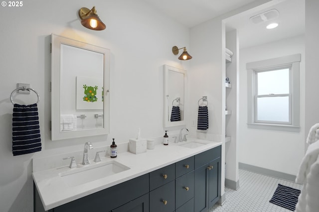 bathroom featuring double vanity and baseboards