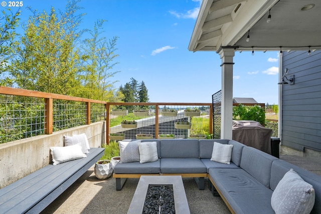 view of patio / terrace with an outdoor living space and fence
