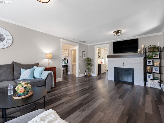 living room featuring ornamental molding, a fireplace, and dark hardwood / wood-style flooring