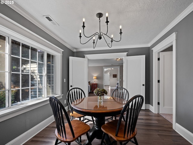 dining space with dark wood-type flooring, crown molding, and an inviting chandelier