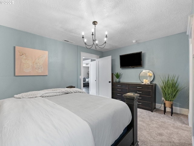 carpeted bedroom with a textured ceiling and a notable chandelier