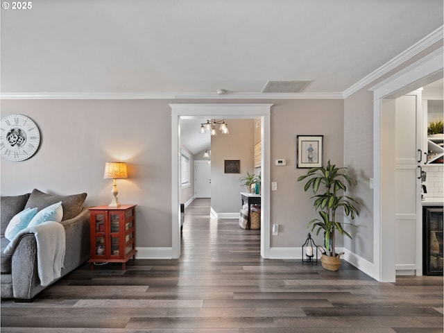 living room featuring beverage cooler, dark hardwood / wood-style flooring, ornamental molding, a chandelier, and vaulted ceiling