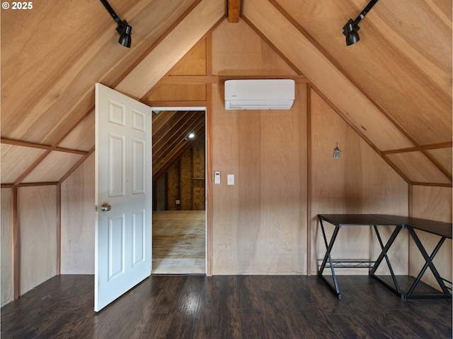 bonus room featuring wood-type flooring, lofted ceiling, a wall unit AC, and wooden walls