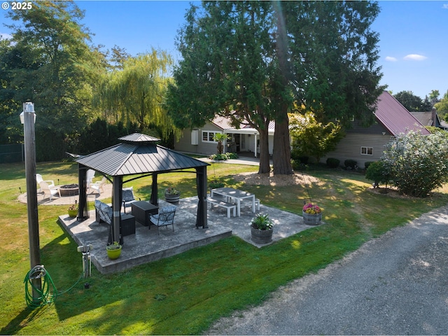 view of yard featuring an outdoor living space with a fire pit, a gazebo, and a patio