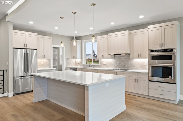 3200 N Abernathy Cir, Ridgefield, WA 98642 - kitchen with appliances with stainless steel finishes, backsplash, light wood-type flooring, and recessed lighting