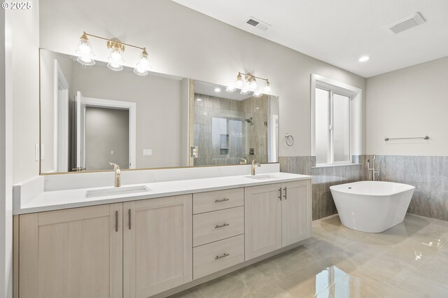 3200 N Abernathy Cir, Ridgefield, WA 98642 - full bathroom featuring tile walls, a shower stall, double vanity, a freestanding bath, and wainscoting