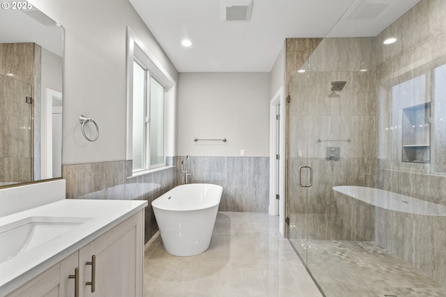 3200 N Abernathy Cir, Ridgefield, WA 98642 - full bathroom with a stall shower, tile walls, vanity, a freestanding tub, and wainscoting