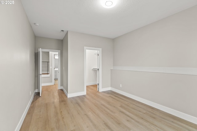 3200 N Abernathy Cir, Ridgefield, WA 98642 - unfurnished bedroom with light wood finished floors, a spacious closet, baseboards, and a closet