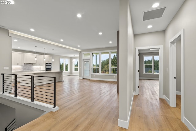3200 N Abernathy Cir, Ridgefield, WA 98642 - hall featuring healthy amount of natural light, light wood-type flooring, an upstairs landing, and recessed lighting