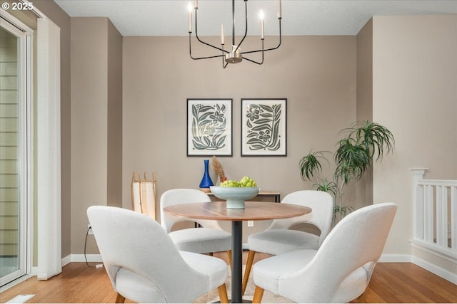 dining room with an inviting chandelier and light hardwood / wood-style floors