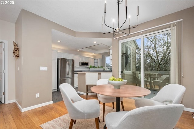 dining space featuring a chandelier and light hardwood / wood-style flooring