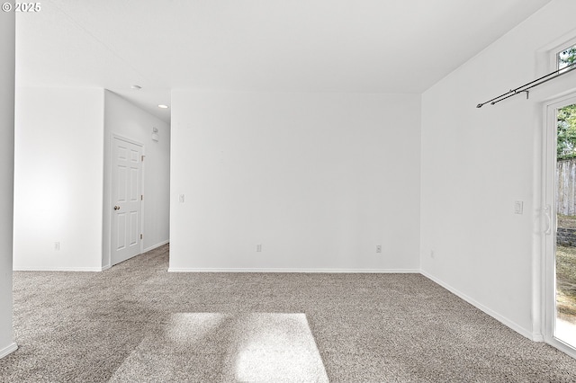 carpeted empty room featuring baseboards and recessed lighting