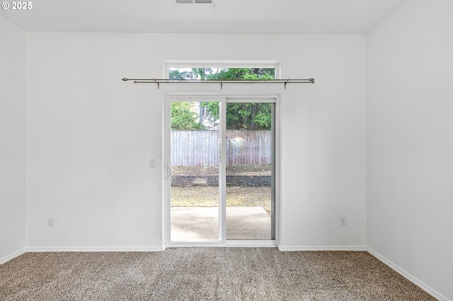 carpeted empty room featuring baseboards