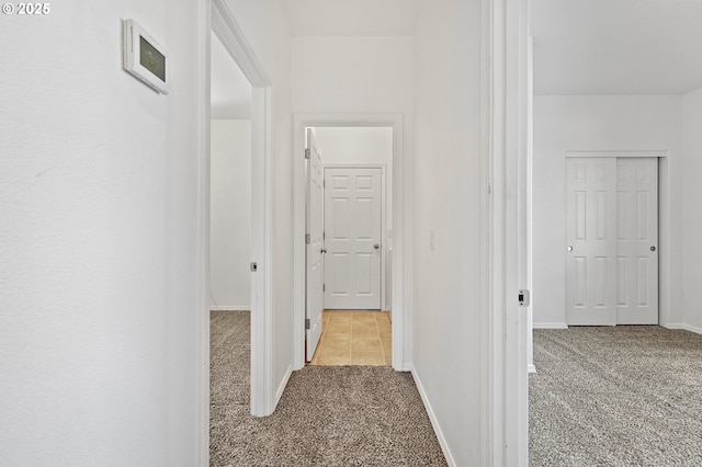 corridor with carpet floors and baseboards