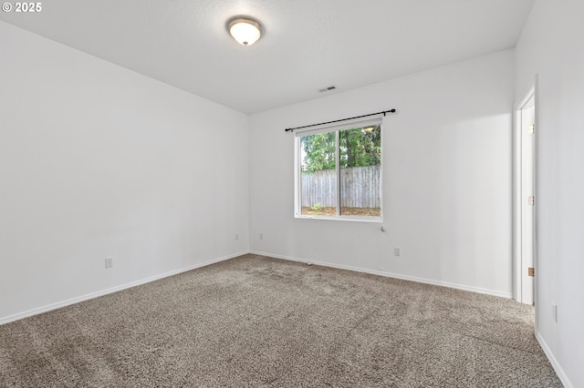 empty room with carpet and baseboards