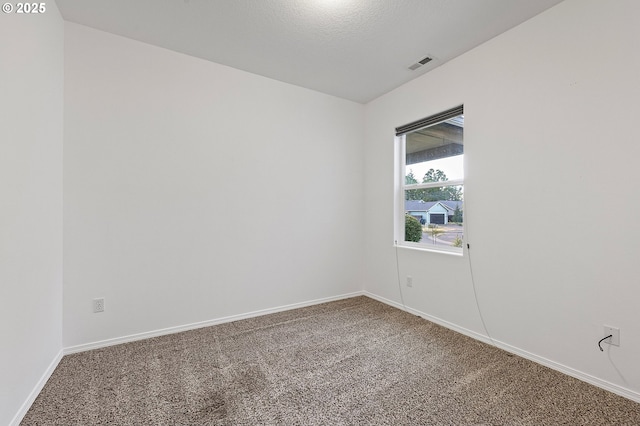 carpeted spare room with baseboards