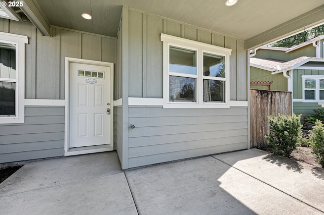 property entrance featuring board and batten siding