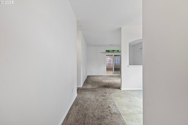 hallway with light carpet and baseboards