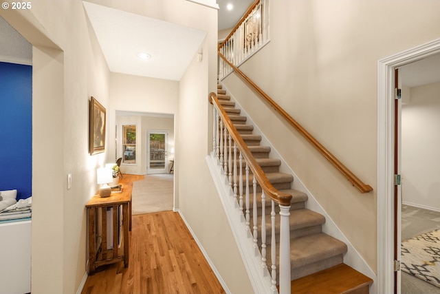 stairs featuring wood-type flooring