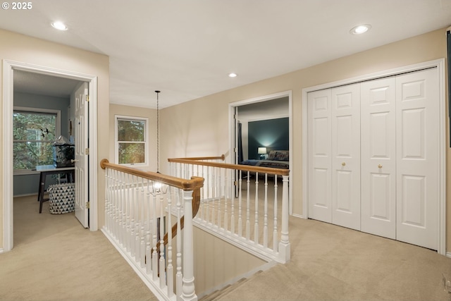 corridor featuring light colored carpet