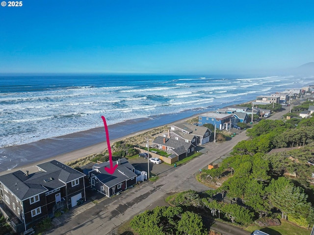 bird's eye view featuring a water view and a beach view